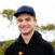 Portrait of smiling handsome young man with cap, background with copy space, full frame horizontal composition